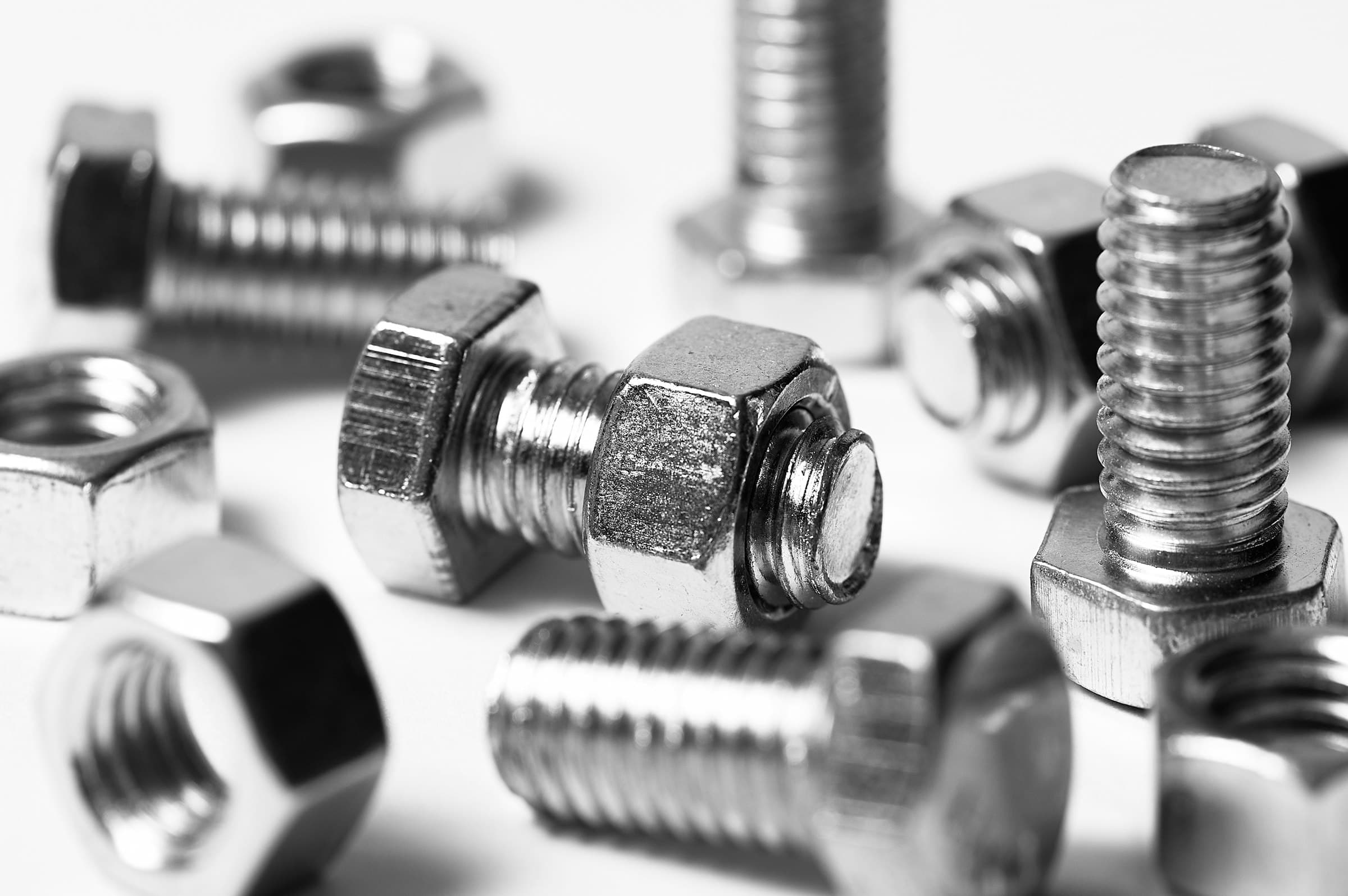 Macro shot of stainless steel hex bolts and nuts